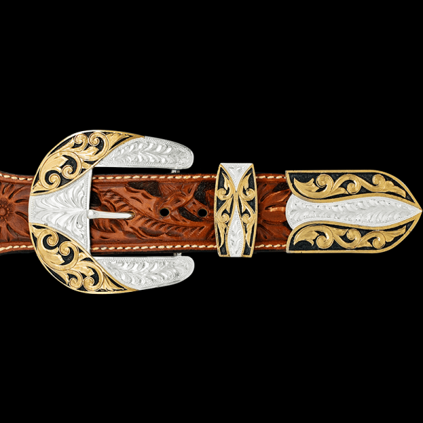 Our Bandera Three Piece Buckle Set is the true embodiment of the Wild West. Featuring a hand engraved silver base adorned with golden Jeweler's Bronze scrollwork and black enamel. Order it now!